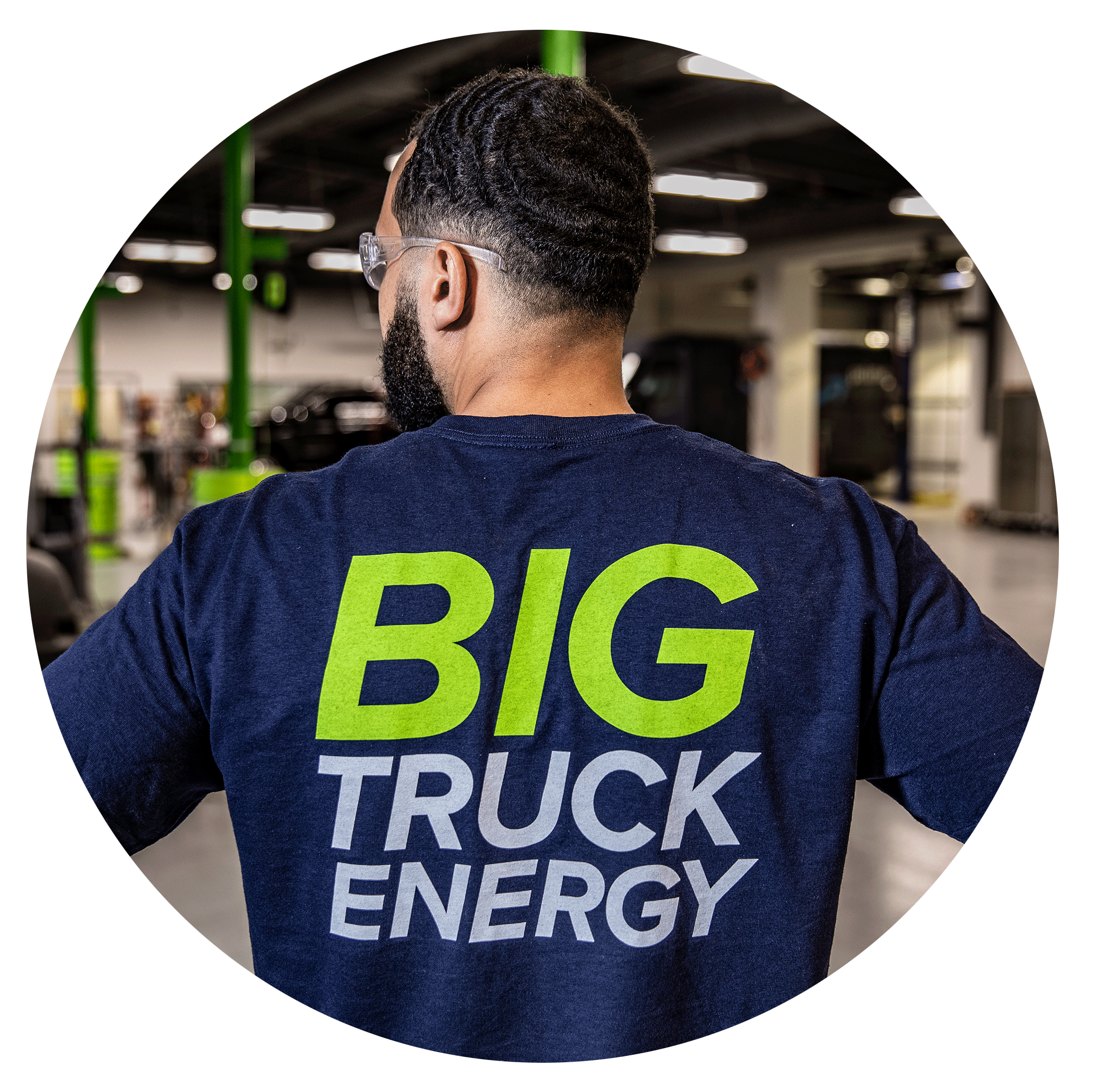 worker wearing company shirt standing in shop